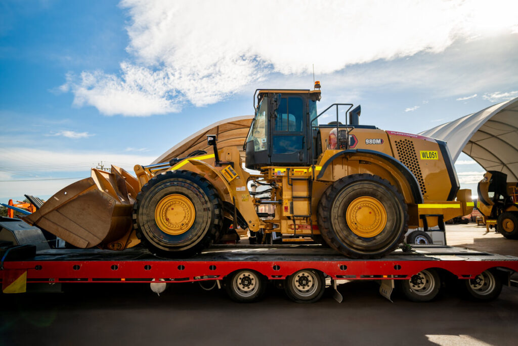 Wheel loader waiting at load out while trucks queue