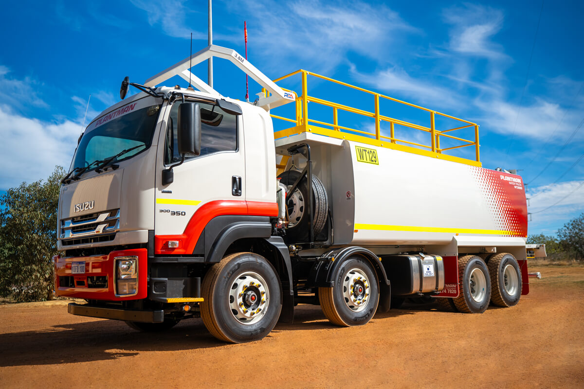 Plantman WT129 20000 Litre water truck with yellow guardrail and hose-reel mounted on 8×4 chassis at a mining yard.